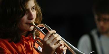 Student playing brass instrument
