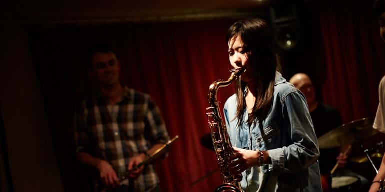 Student playing a saxaphone