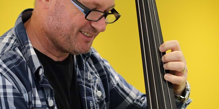 Zoltan Dekany - Man Smiling Playing Double Bass
